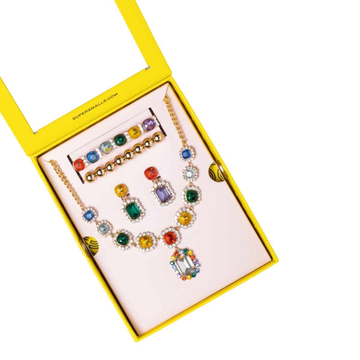 A gold-tone jewelry set with multiple colorful gemstone accents, displayed inside a bright yellow box on a white background.