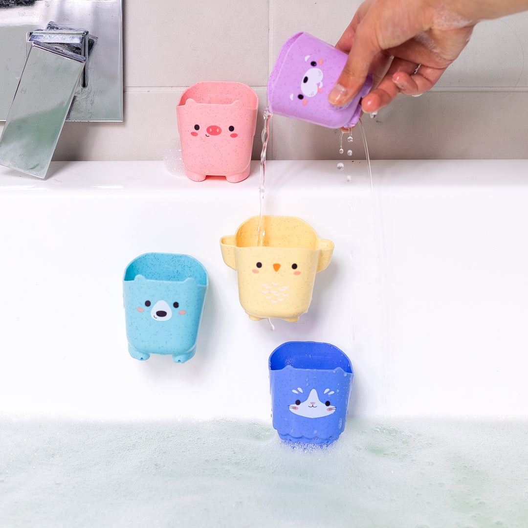 Colorful bath toy buckets hanging from a shower head with water flowing.