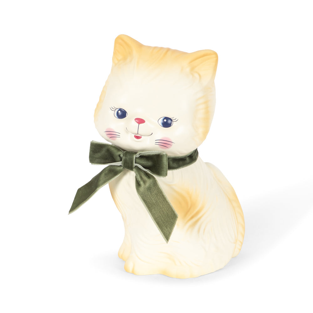 Cat-shaped money box with a green bow on a white background