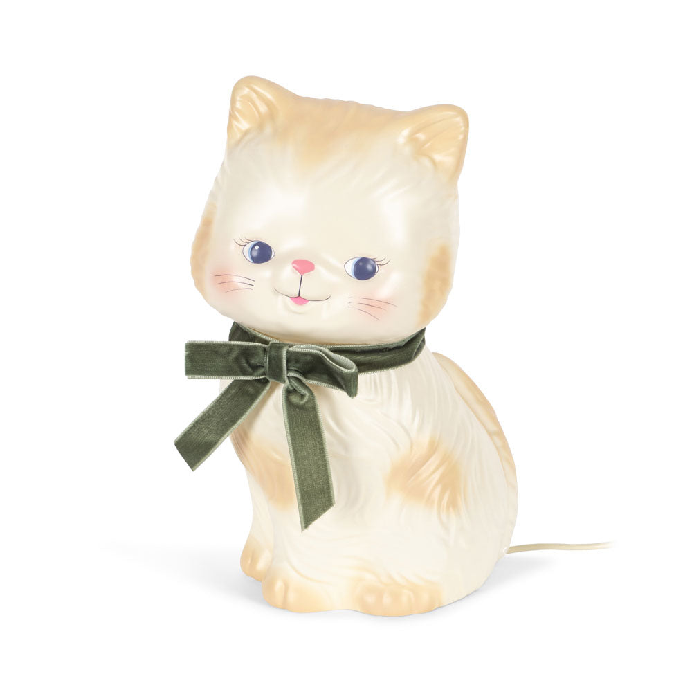 Cat-shaped night light with a green bow on a white background