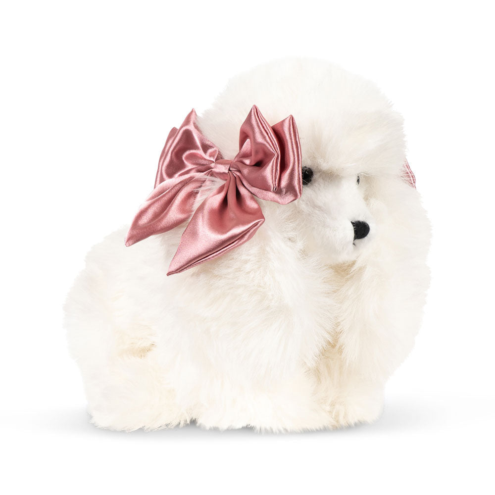 White fluffy toy with a pink bow on a white background