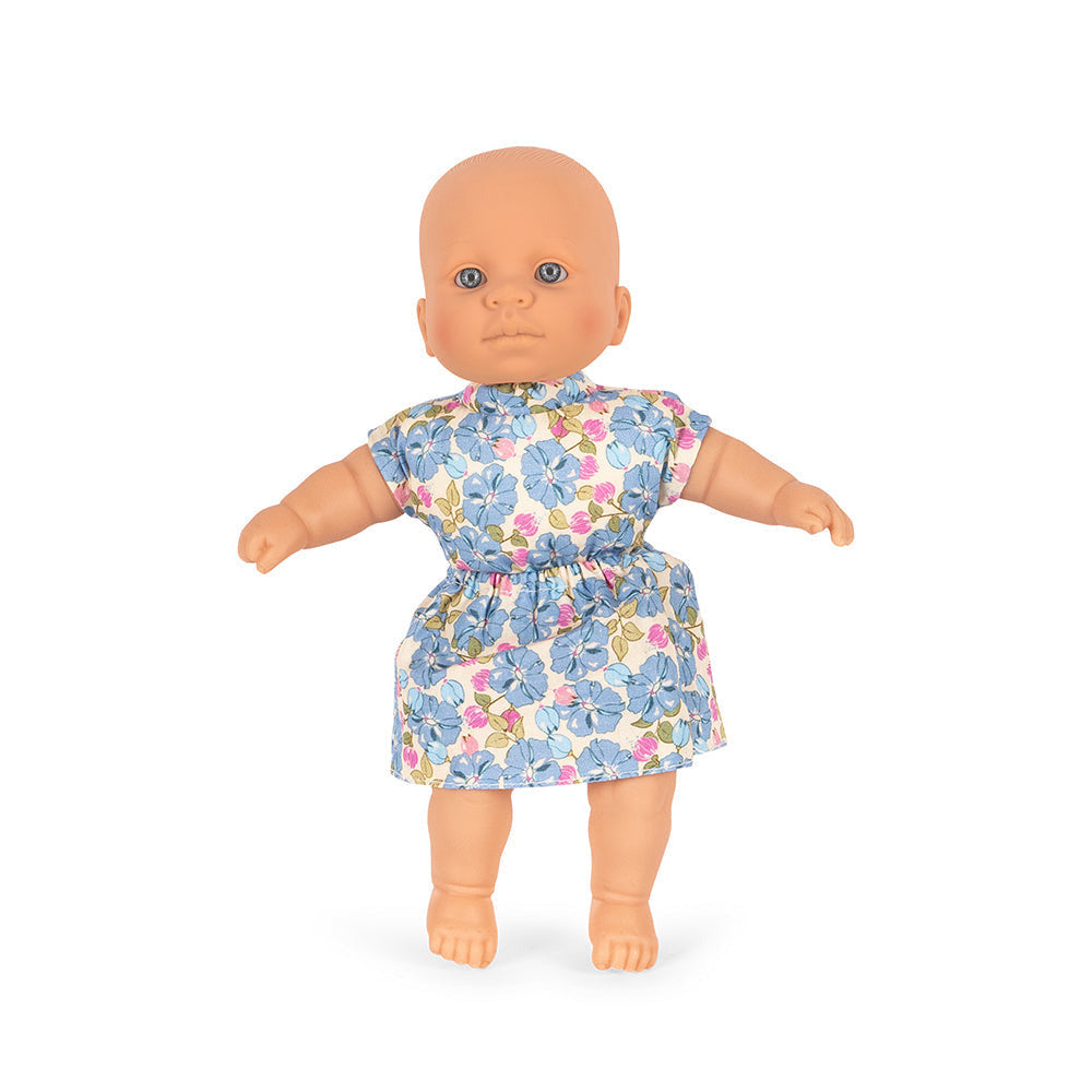 Baby doll wearing a floral dress on a white background