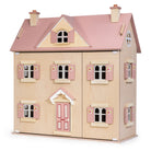 A wooden dollhouse styled like a two-story house, featuring a light natural wood body, a pink roof, pink shutters, and a pink front door with small floral details.
