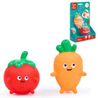 Two children's bath toys shaped like a tomato and a carrot, shown alongside their retail packaging on a white background. The brand Philips is visible on the box.