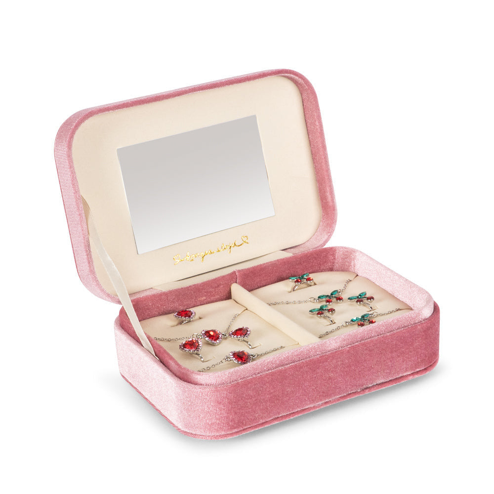 Pink jewelry box with mirror lid containing earrings on a white background