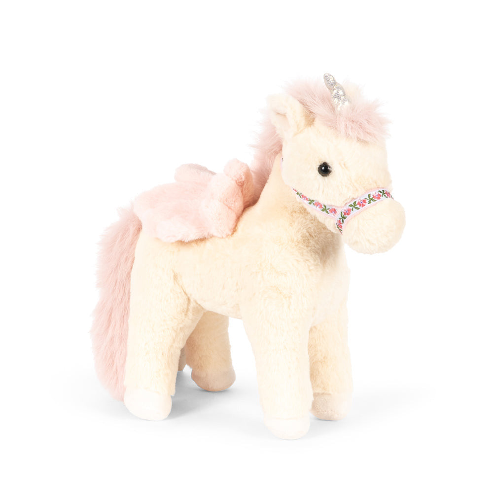 A plush unicorn toy in cream with pink mane, tail, and wings, featuring a small silver horn and a pink patterned bridle, set against a plain white background.