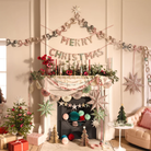 Decorated living room with Meri Meri Christmas decorations, including a fireplace, garlands, and presents.