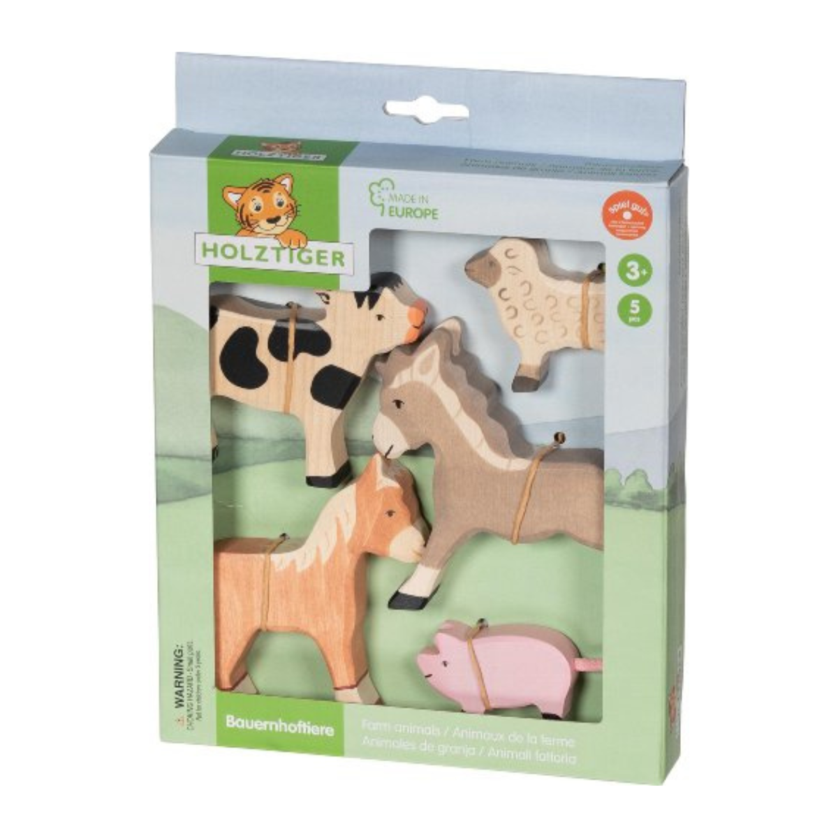 Holztiger wooden farm animal toy set in its original packaging, featuring natural wood horses, a black and white cow, a sheep, and a pink pig on a green illustrated background.