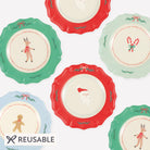 Set of colorful plates with Christmas-themed designs on a white background, featuring the brand 'Reusable'.
