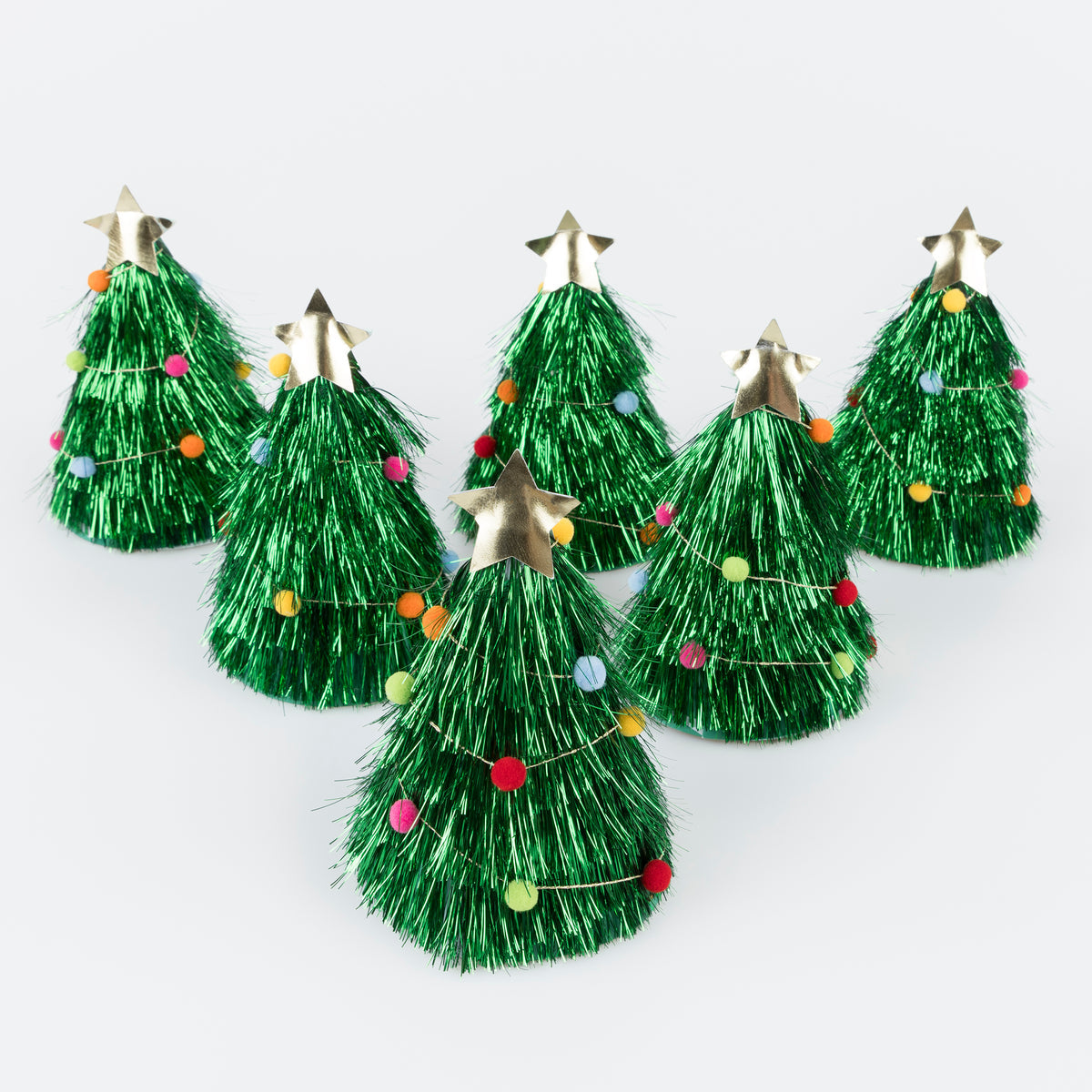 Set of six green tinsel Christmas trees with star toppers on a white background