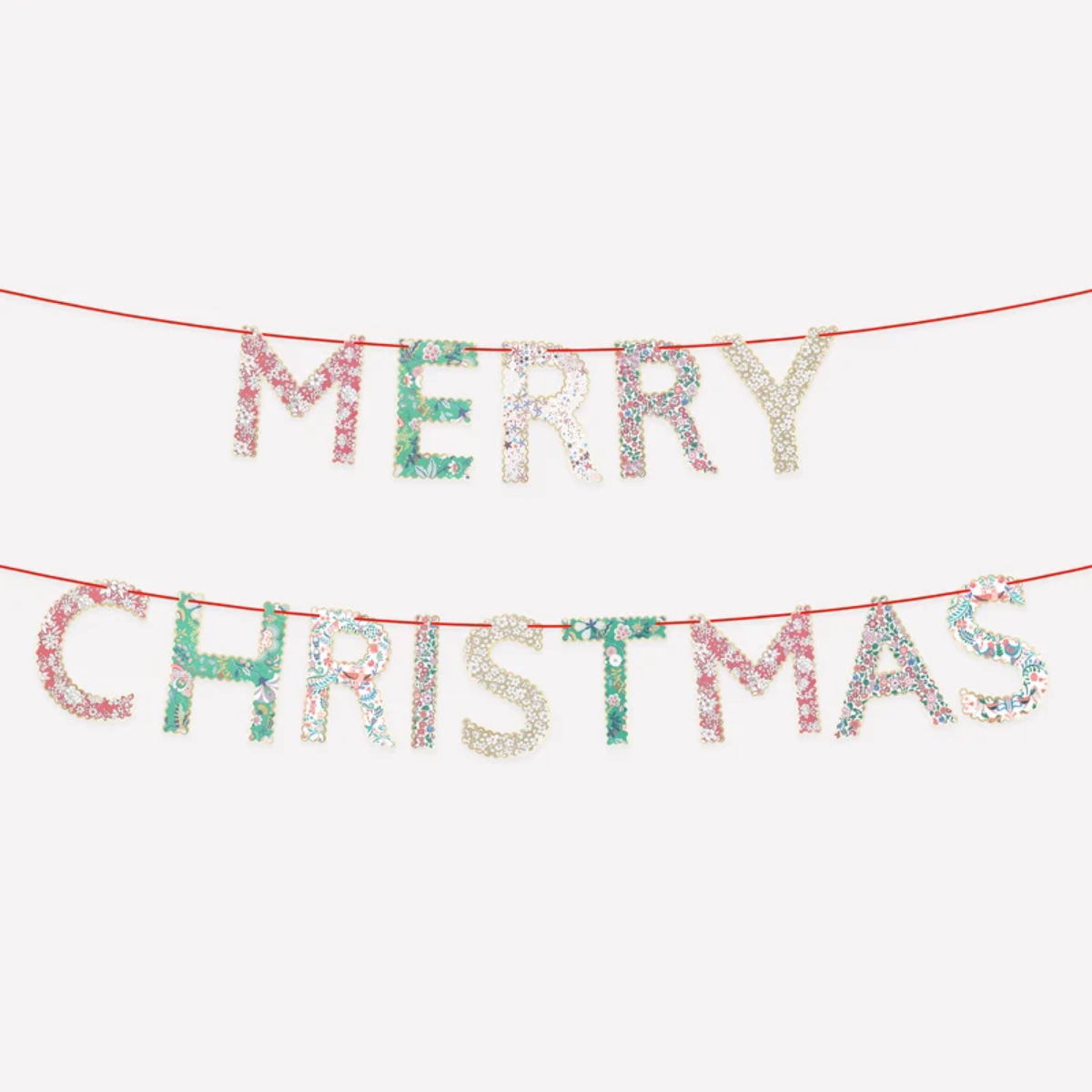 Merry Christmas letter banner with glittery letters on a red string, displayed against a plain light gray background.
