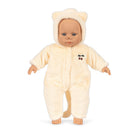 Doll wearing a cream-colored bear onesie on a white background