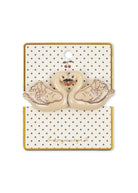 A  swan-shaped konges slojd hair clip displayed on a branded backing card. The hair clips are cream-colored with brown feather detailing and a small orange beak, attached to a cream card with blue polka dots and a gold border.